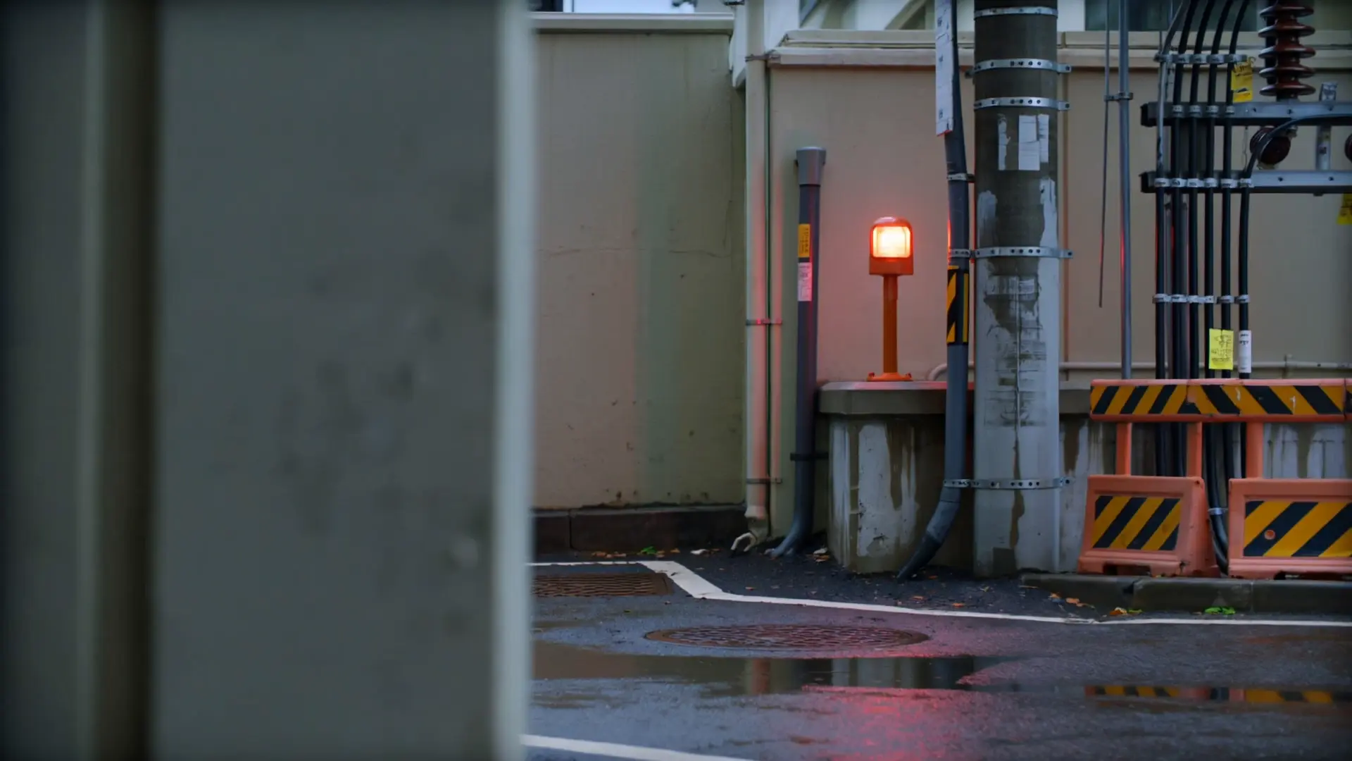 Utility poles, cable bundles and safety barriers in a rain-washed service lane